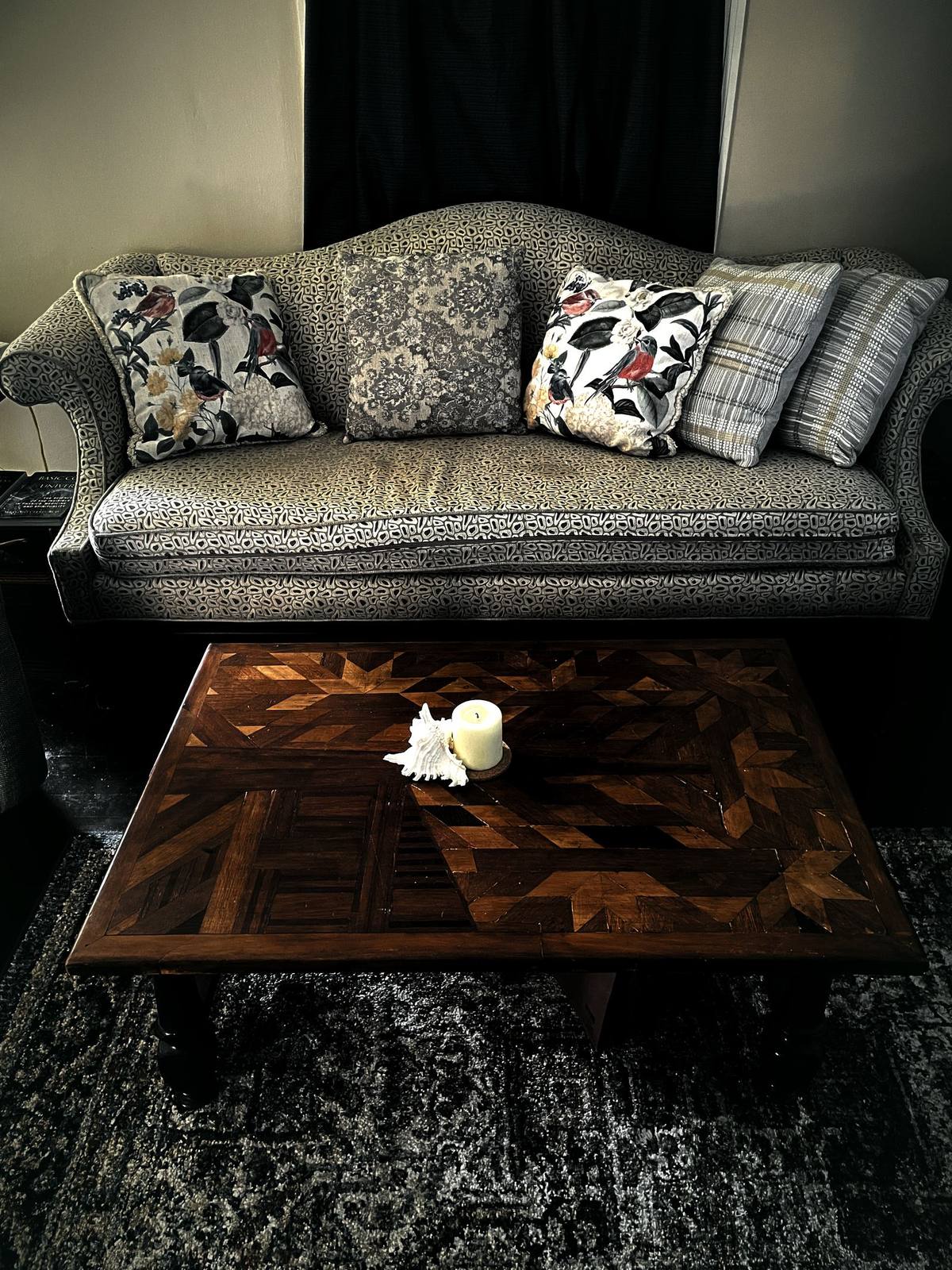 A lit table in a room, with objects set down on it